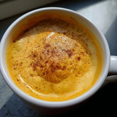 Vibrant purple Korean sweet potato latte poured into two ceramic mugs
