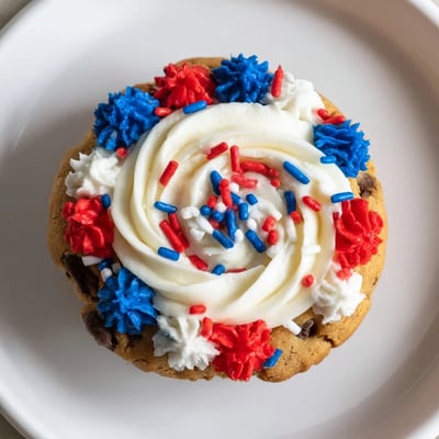 Bite-sized cookie cups filled with creamy frosting and colorful sprinkles, perfect for summer parties.  