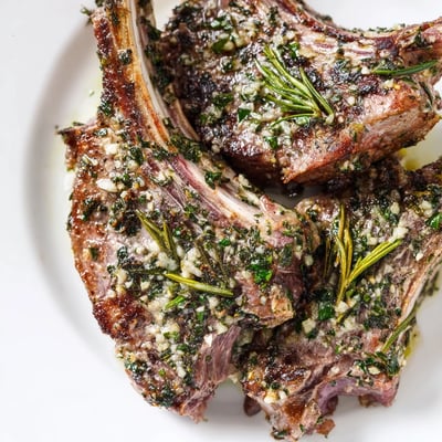 Fresh rosemary and garlic crust on tender lamb chops served with lemon wedges.  